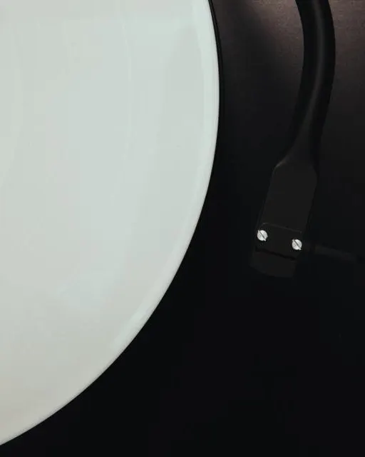 A white vinyl record on a turntable